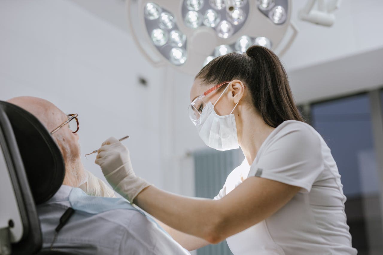 Dental hygienist examining a patient's teeth during a routine check-up