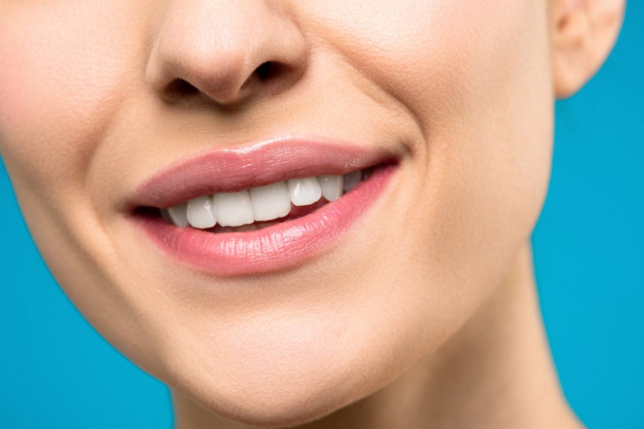 Close-up of a bright white smile against a blue background
